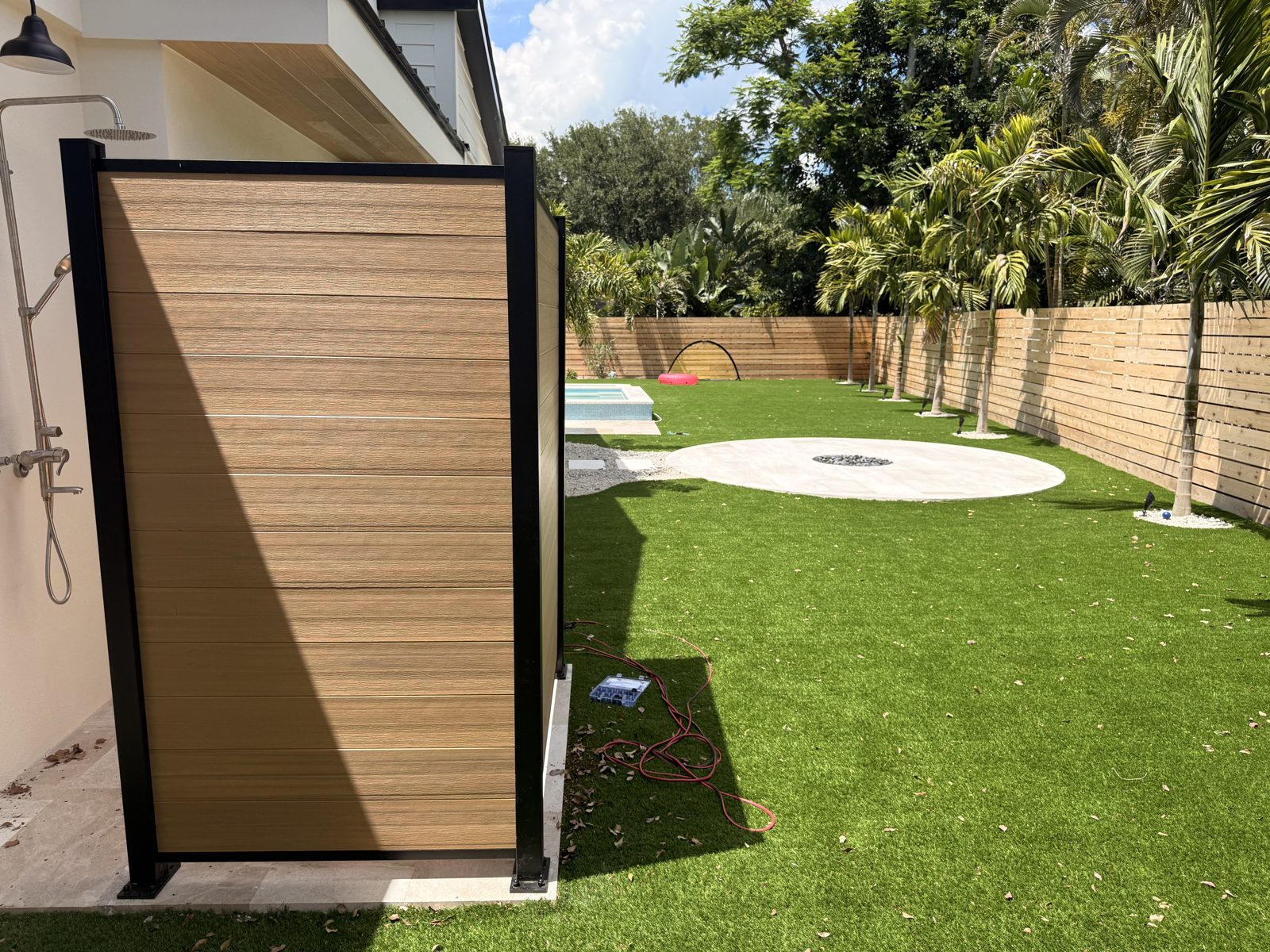 Modern composite gate with black metal frame installed in Sarasota