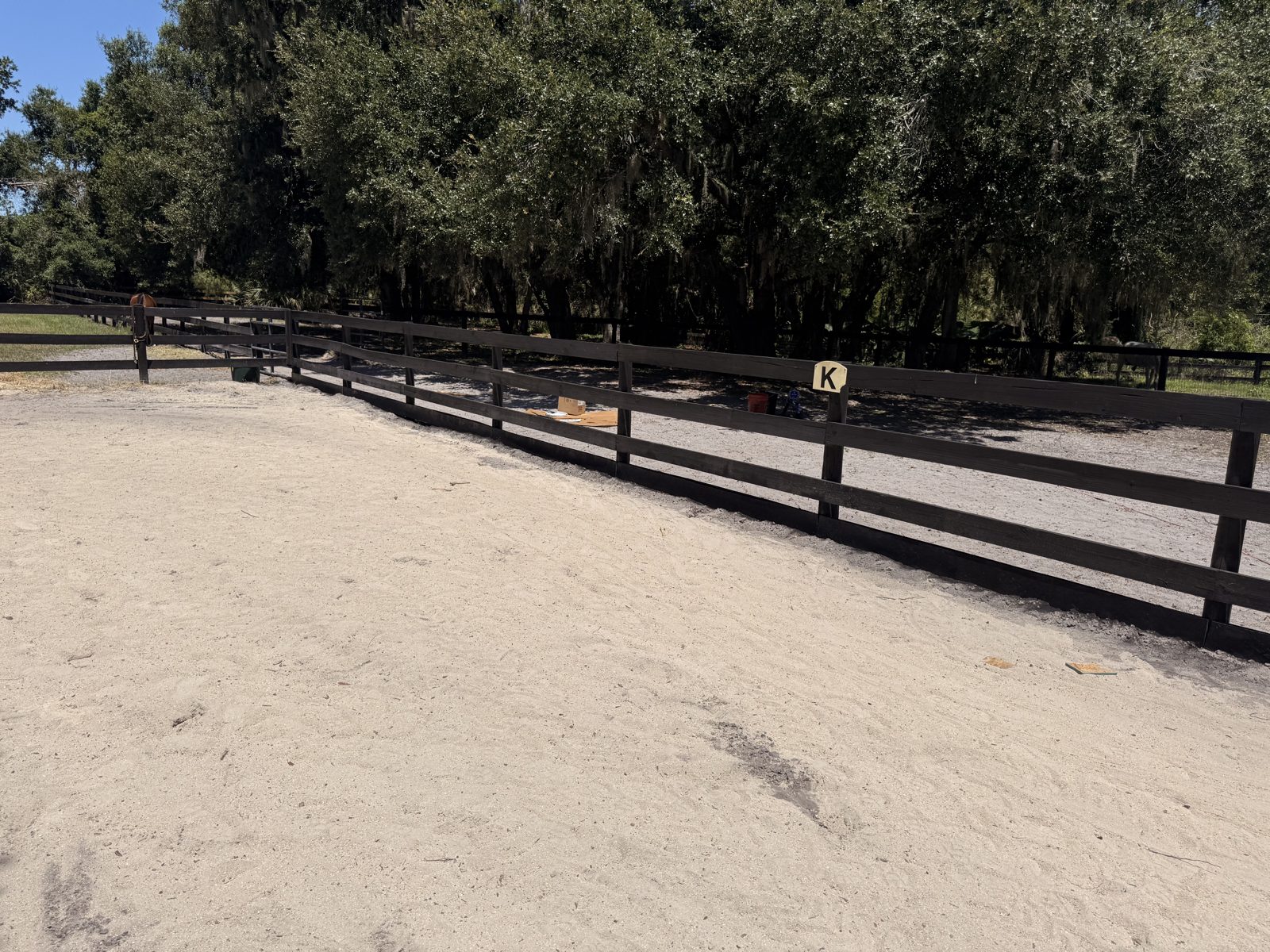Dark stained split-rail fence at an equestrian property in Sarasota County