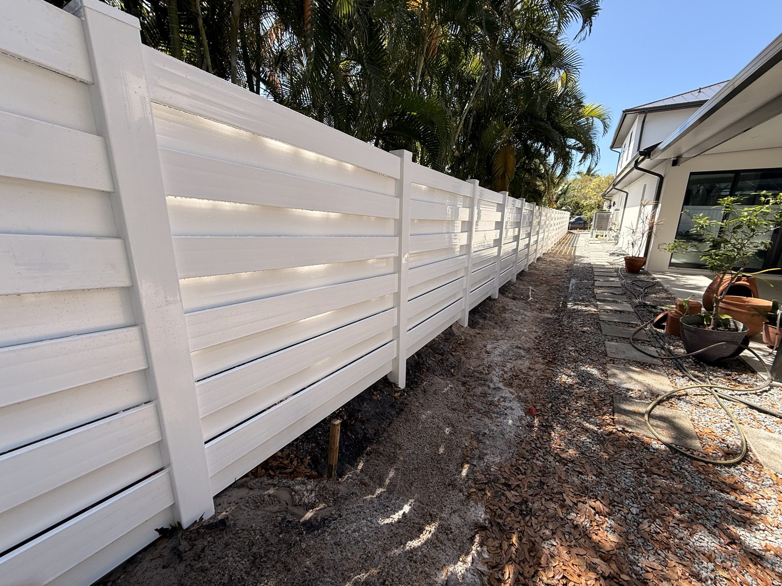 White vinyl horizontal privacy fence installed in a Sarasota backyard