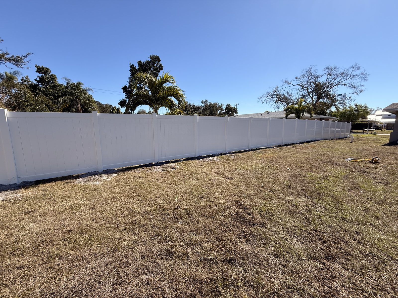 Completed white vinyl privacy fence installed by Walker Fence and Gate in Sarasota